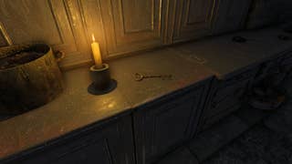 The player looks at the Castle Key on a kitchen counter in Atomfall
