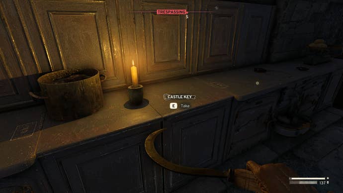 The player looks at the Castle Key on a kitchen counter in Atomfall