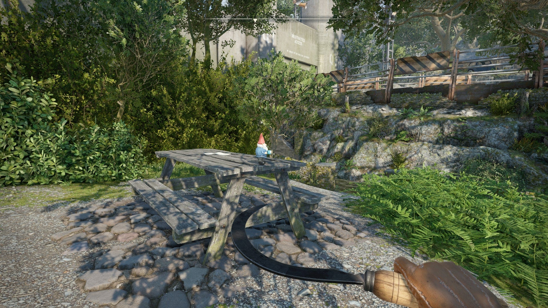 The player looks at a gnome sat on a picnic table in Wyndham Village in Atomfall - 15