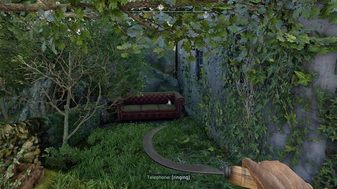 The player looks at a gnome sat on a sofa in Wyndham Village in Atomfall