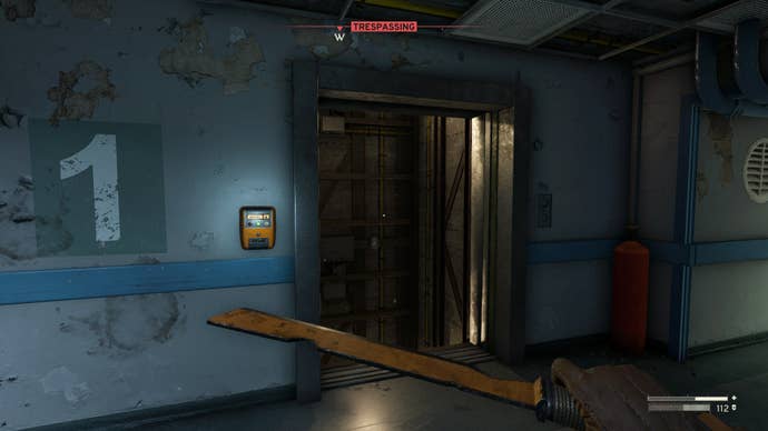 The player looks at the broken elevator on the first floor of medical in Atomfall