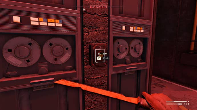 The player looks at a button on a server tower inside of Data Store Charlie in Atomfall