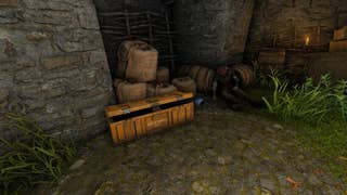The player looks at an open BARD Crate beside a Druid corpse in the Druid's Castle Ruins in Atomfall