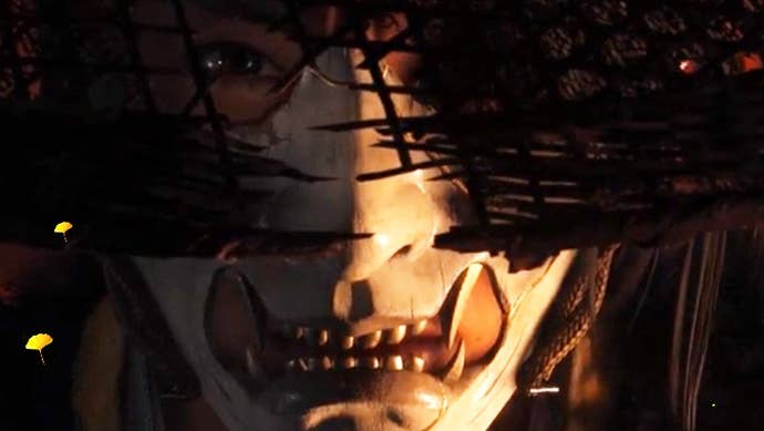 Atsu looks up from behind a mask in Ghost of Yōtei