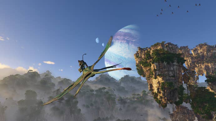 A Na'vi rides an ikran – a reptile-like avian creature - against the blue skies of Avatar: Frontiers of Pandora, with a pair of planets visible in the skies above.