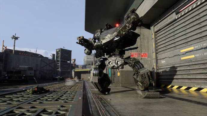 Avatar: Frontiers of Pandora: a military installation with a massive, man-made mech posing with its weapons primed.