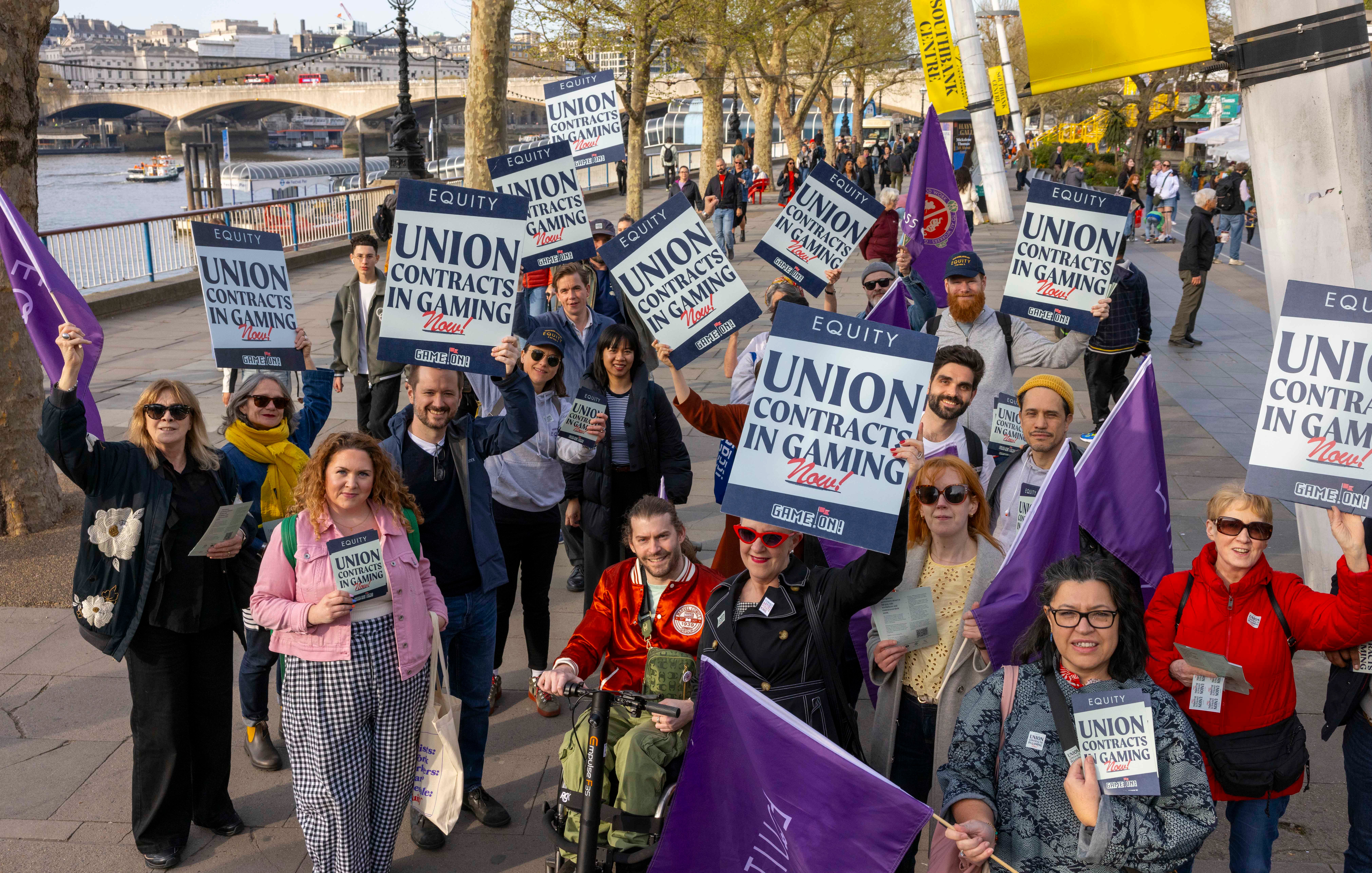 Photo of protestors holding &ldquo;Union contracts in gaming&rdquo; placards in a large group