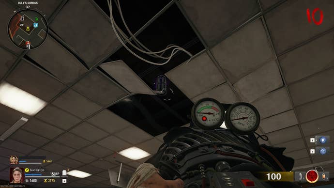 The player aims the Jet Gun at an LTG component in the ceiling of Olly’s Comics in Call of Duty: Black Ops 6