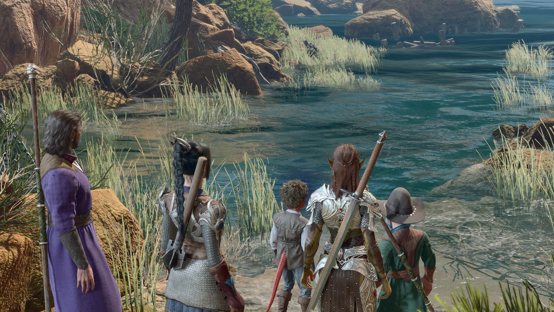 Baldur&rsquo;s Gate 3 image showing a party standing by the water with a young Tiefling, on a small patch of beach.