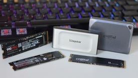 Some of the best SSDs for gaming, including NVMe and external SSDs, arranged in front of a keyboard.