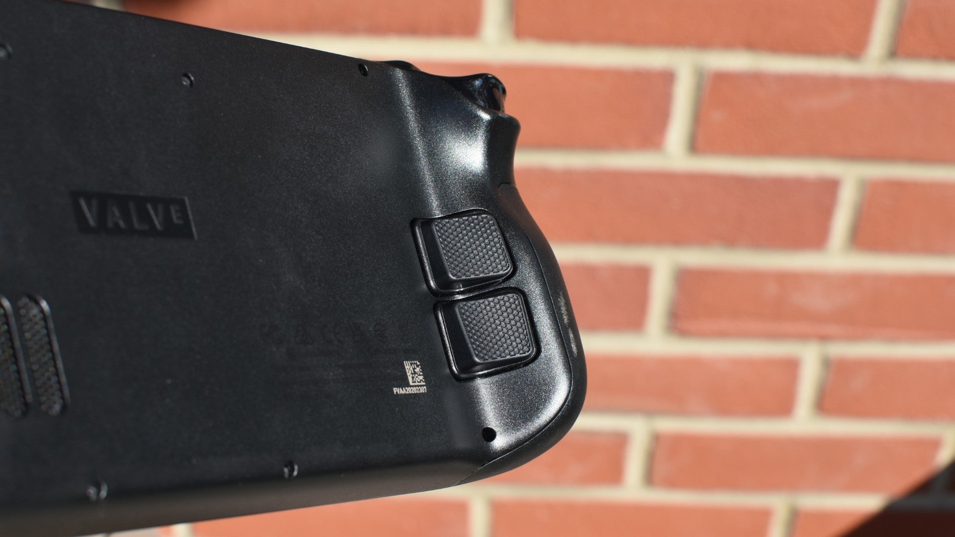 A close-up of the PlayVital Back Button Enhancement Set installed on a Steam Deck. - 13