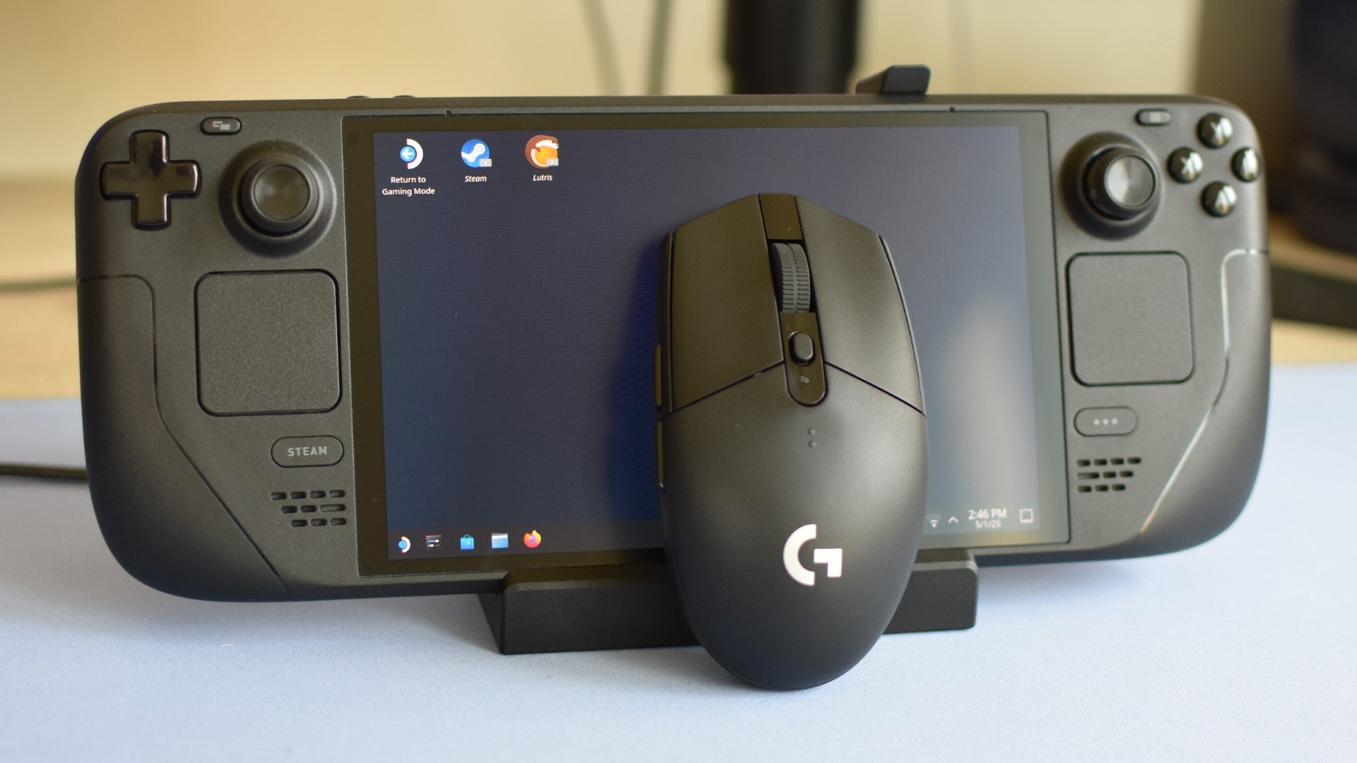 The Logitech G305 Lightspeed mouse propped up against a Steam Deck. - 4
