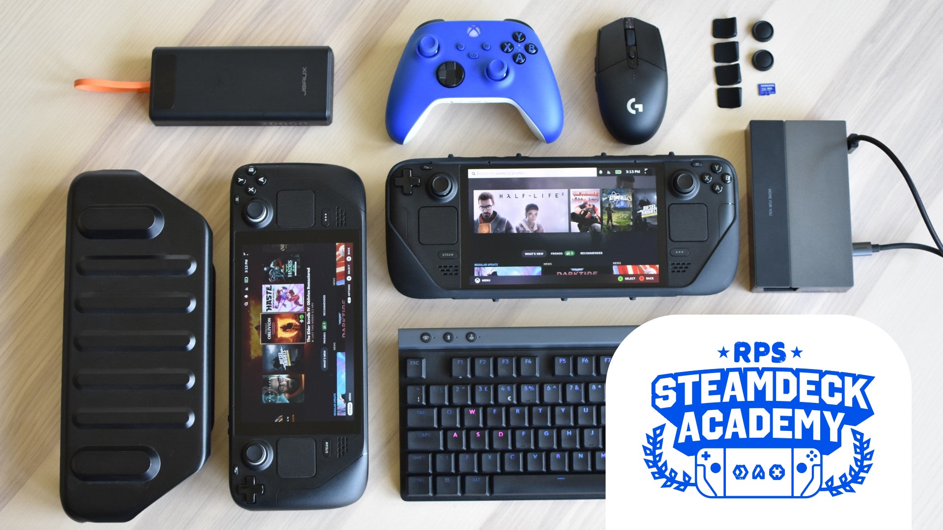 Some of the best Steam Deck accessories, and a couple of Steam Decks, laid out on a table. The RPS Steam Deck Academy logo is added in the bottom-right corner. - 1