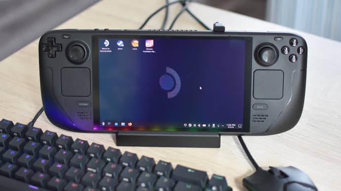 A Steam Deck, docked in a Valve Steam Deck Docking Station, with a mouse and keyboard connected to the latter.