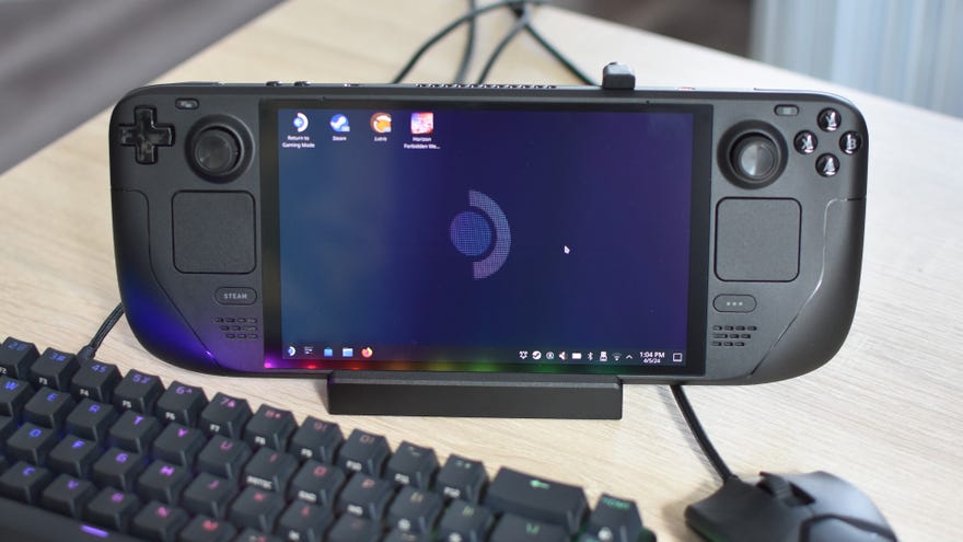 A Steam Deck, docked in a Valve Steam Deck Docking Station, with a mouse and keyboard connected to the latter.
