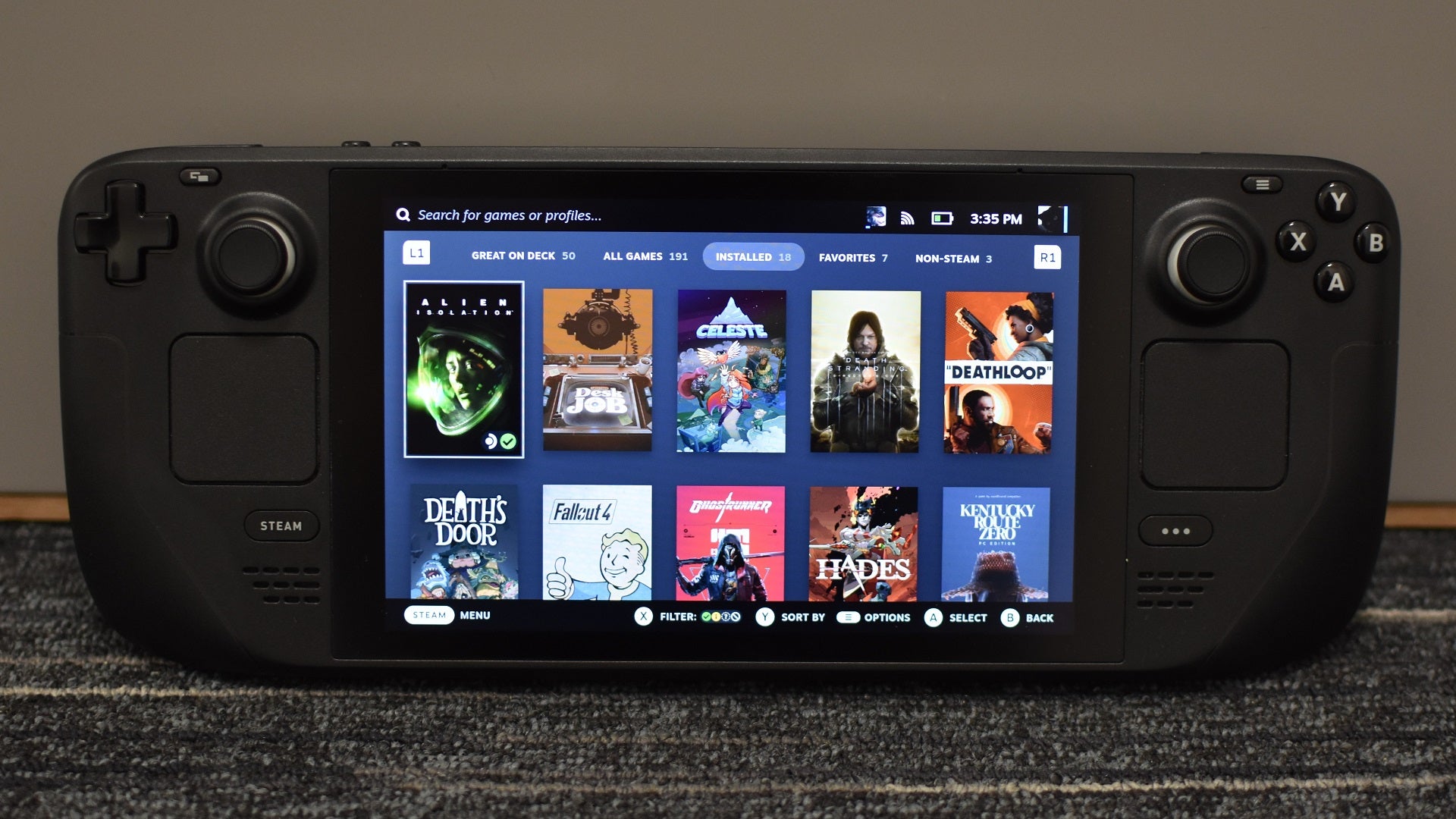 A Steam Deck with the user&rsquo;s Steam library screen visible, showing various installed games.