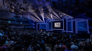 Photo of the Blizzcon 2023 stage with a BlizzCon logo on the big screen and a packed crowd of attendees
