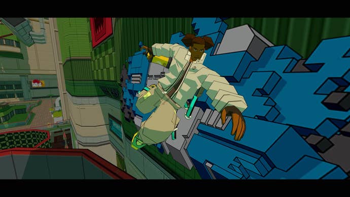 A man holds a can of spray paint next to a large graffiti mural