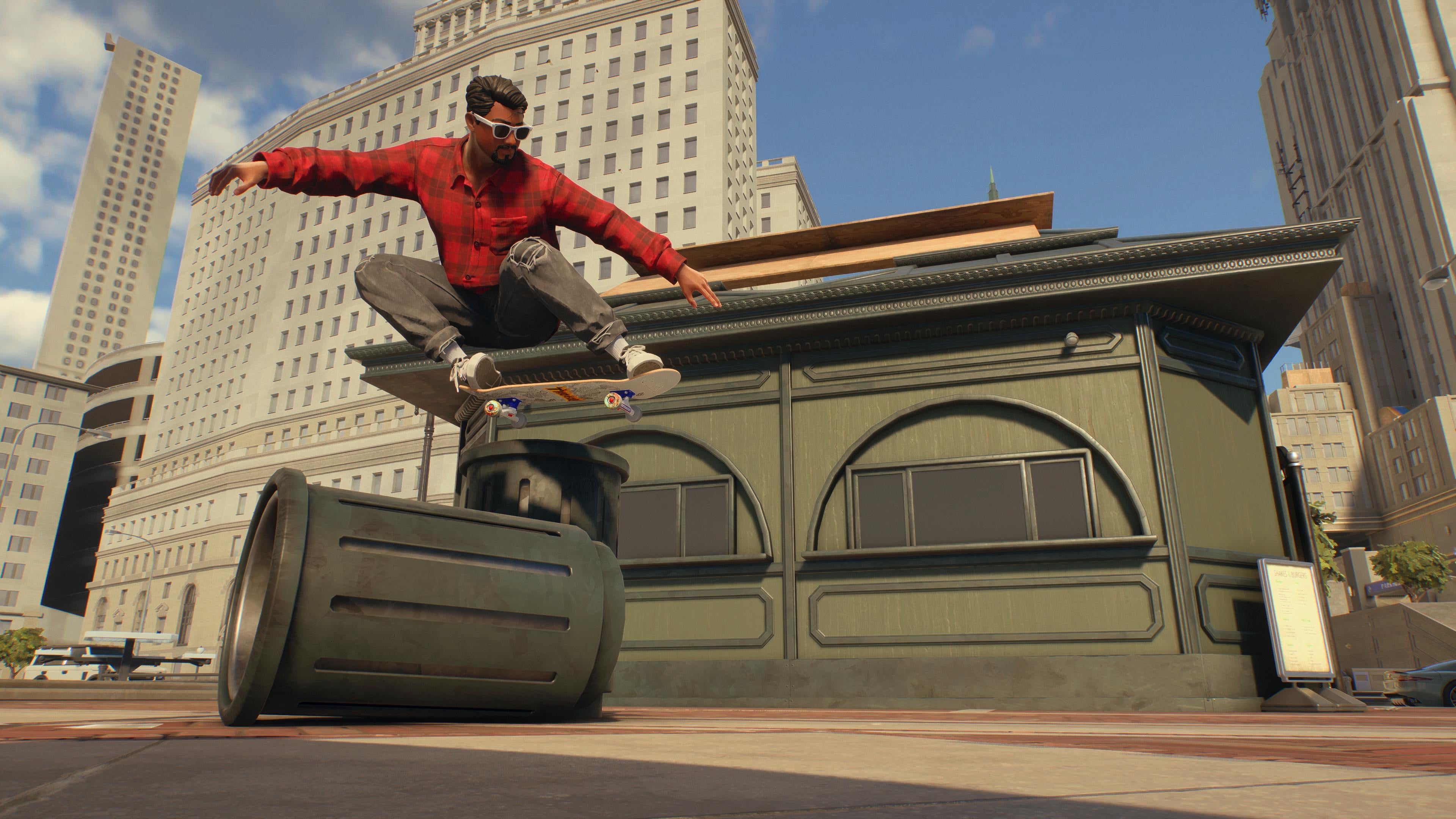 A Skate. player performing a boned ollie move over a trashcan with high city blocks behind.