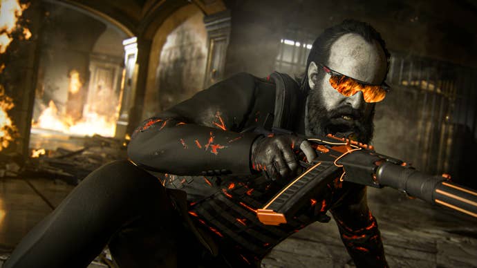 Call of Duty Black Ops 6 image showing a bearded male character sliding along the floor, gun in hand and fire reflected in his sunglasses