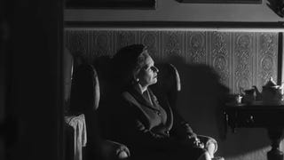 Black and white still from Call of Duty: Black Ops 6's live action trailer showing a female politician looking off into the distance