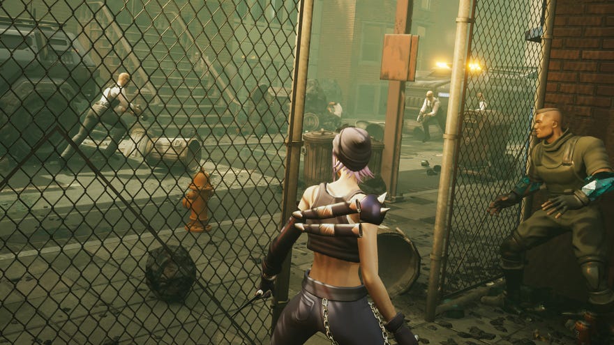 Two superheroes hide behind a wire fence in Capes