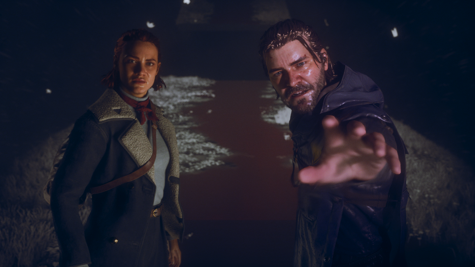 Dylan and Jesse Faden look towards the camera, Dylan sticking his hand out, in Control Resonant.