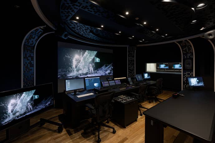 A dark Control Room in Kojima Productions with desks and screens and sound equipment