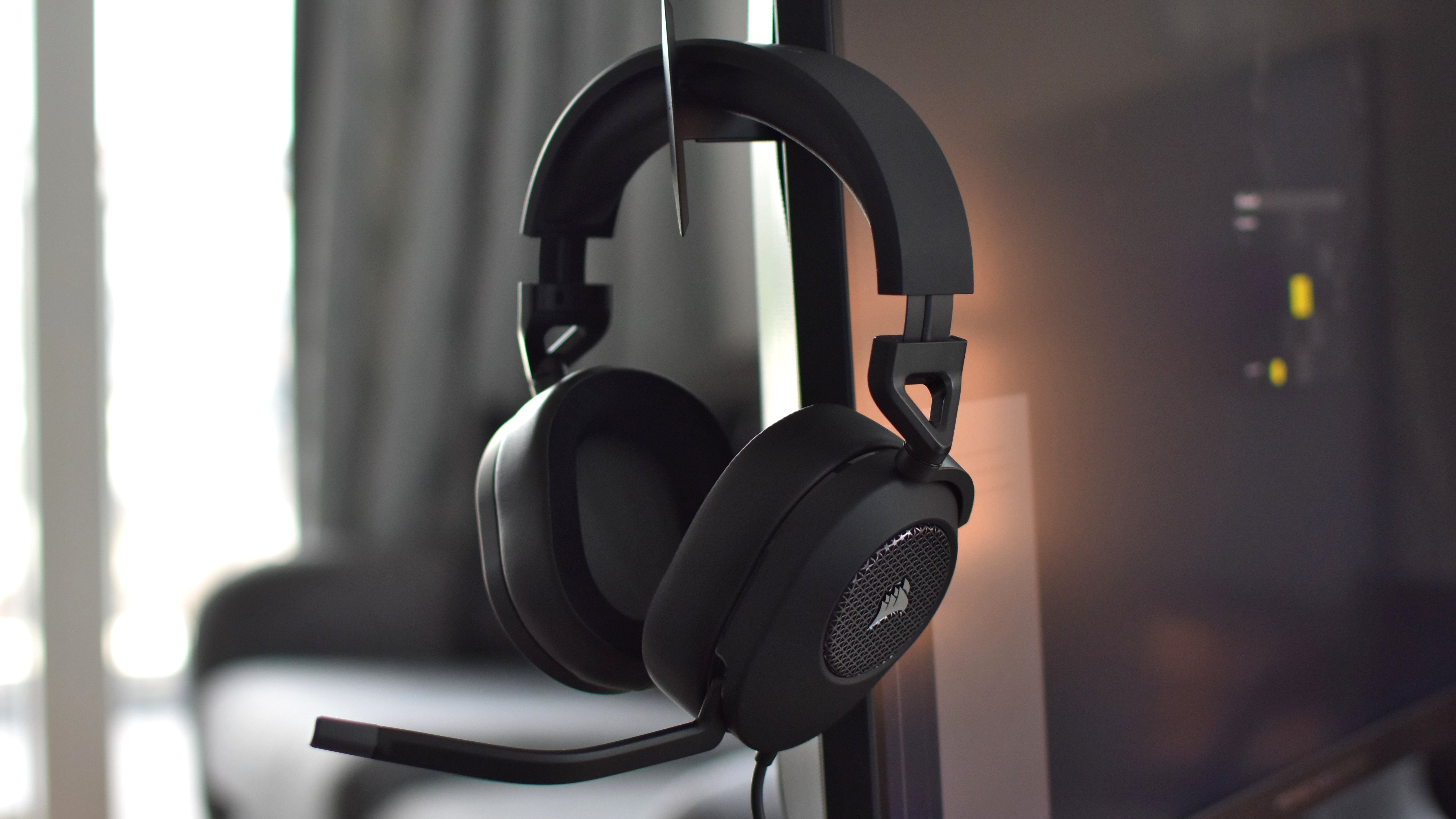 The Corsair HS65 Stereo gaming headset, hanging on monitor&rsquo;s pop-up headset hook.