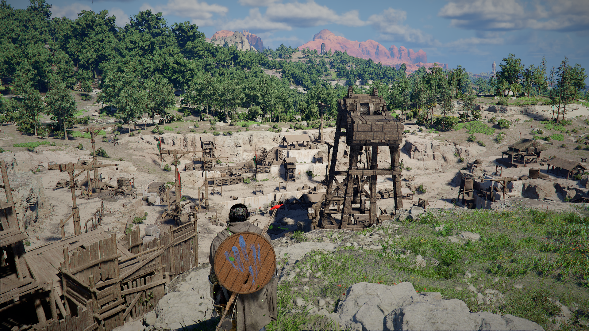 Crimson Desert screenshot showing Kliff overlooking some wooden structures in a field