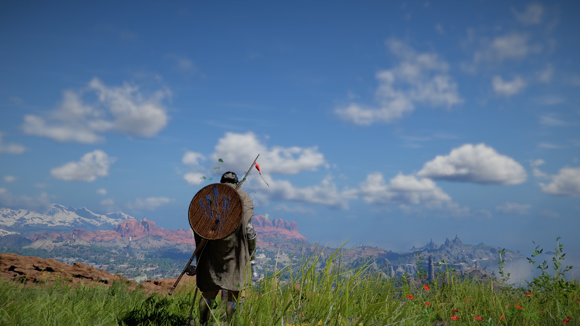 Crimson Desert screenshot showing Kliff, shield on back, looking over a grassy landscape and distant view of blue, faintly cloudy skies