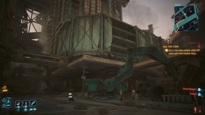 first person view of a crane below a light green building