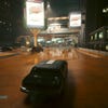 A passing car caught in a puddle's reflection in Cyberpunk 2077: Phantom Liberty, with DLSS 3.5 Ray Reconstruction switched off.