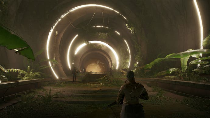 Dune: Awakening in-engine screenshot without the UI showing a player exploring a subterranean tunnel with plantlife