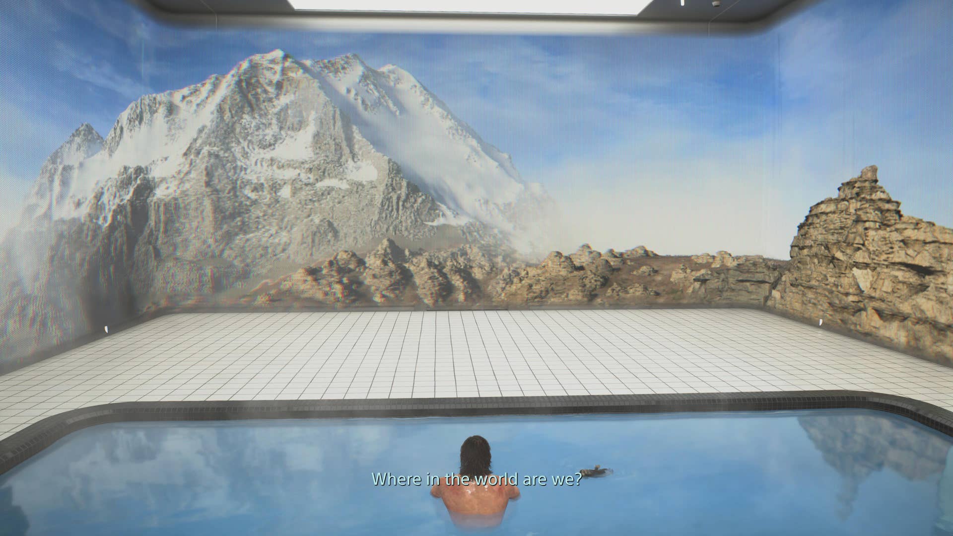 Death Stranding 2 screenshot showing Sam in a pool surrounded by a screen of sorts showing mountains. Dialogue reads: where in the world are we?