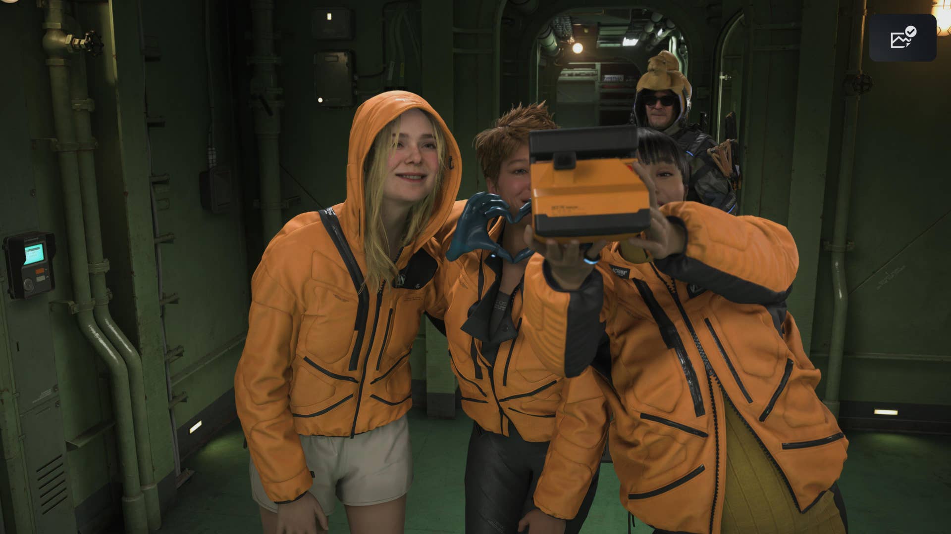 Death Stranding 2 screenshot showing three characters in orange suits taking a selfie with Sam in the background