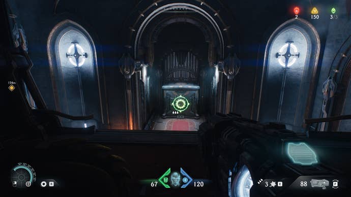 The player looks towards a crate with a green shield sigil on it in the Sentinel Barracks chapter in DOOM: The Dark Ages