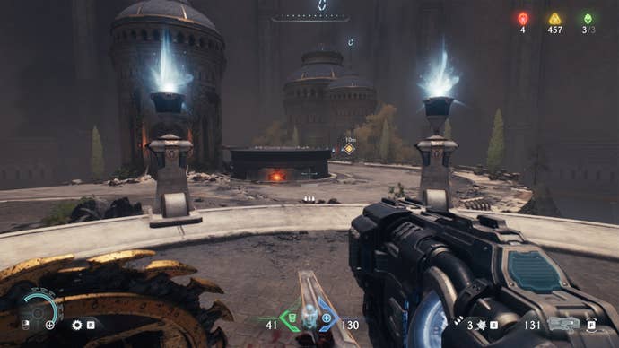 The player - who is standing on a platform with a green sigil on it - aims at some Hot Metal they can Shield Throw at in DOOM: The Dark Ages