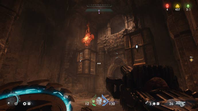 The player aims at some Hot Metal attached to a climbable crate inside a cave in The Siege Part1 chapter of DOOM: The Dark Ages