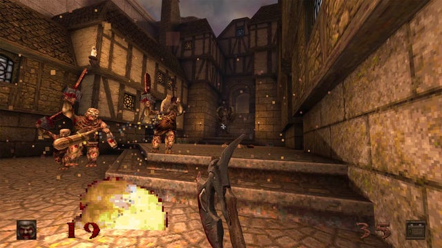 A first-person view of a Quake level in an olden-days town, the Ranger holding an axe.