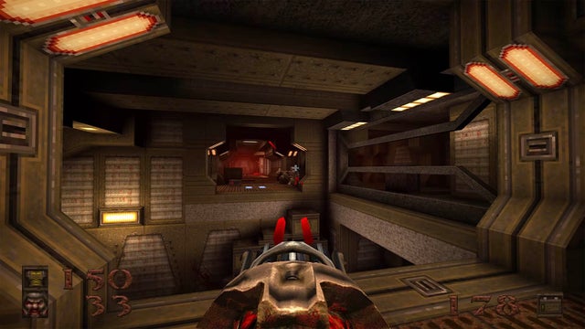 A first-person view where the player is wielding a tubular chaingun while stalking through spaceship-like halls.