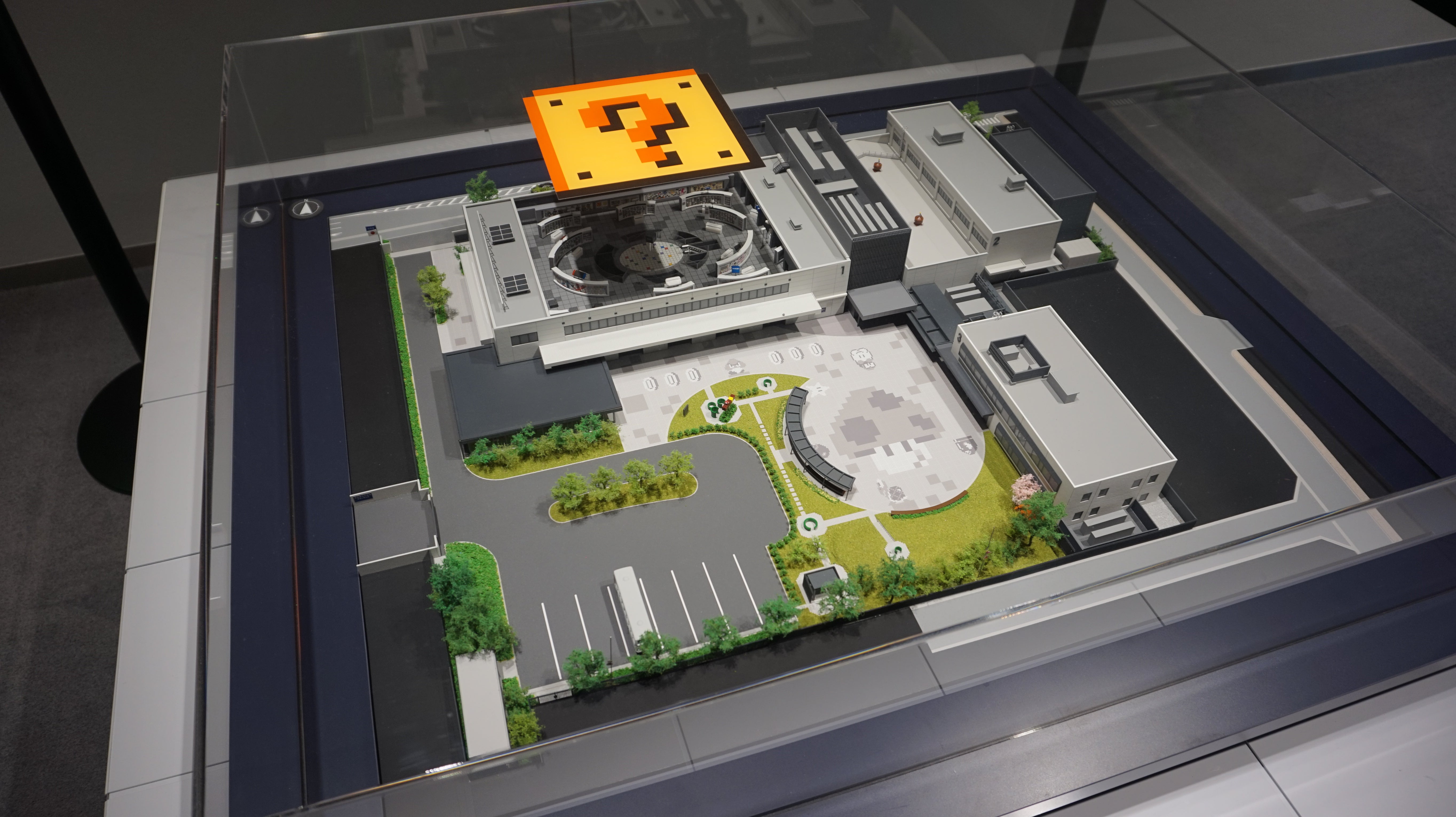 A photograph of a bird&rsquo;s eye model of the Nintendo Museum, with the roof lifted up to see inside.