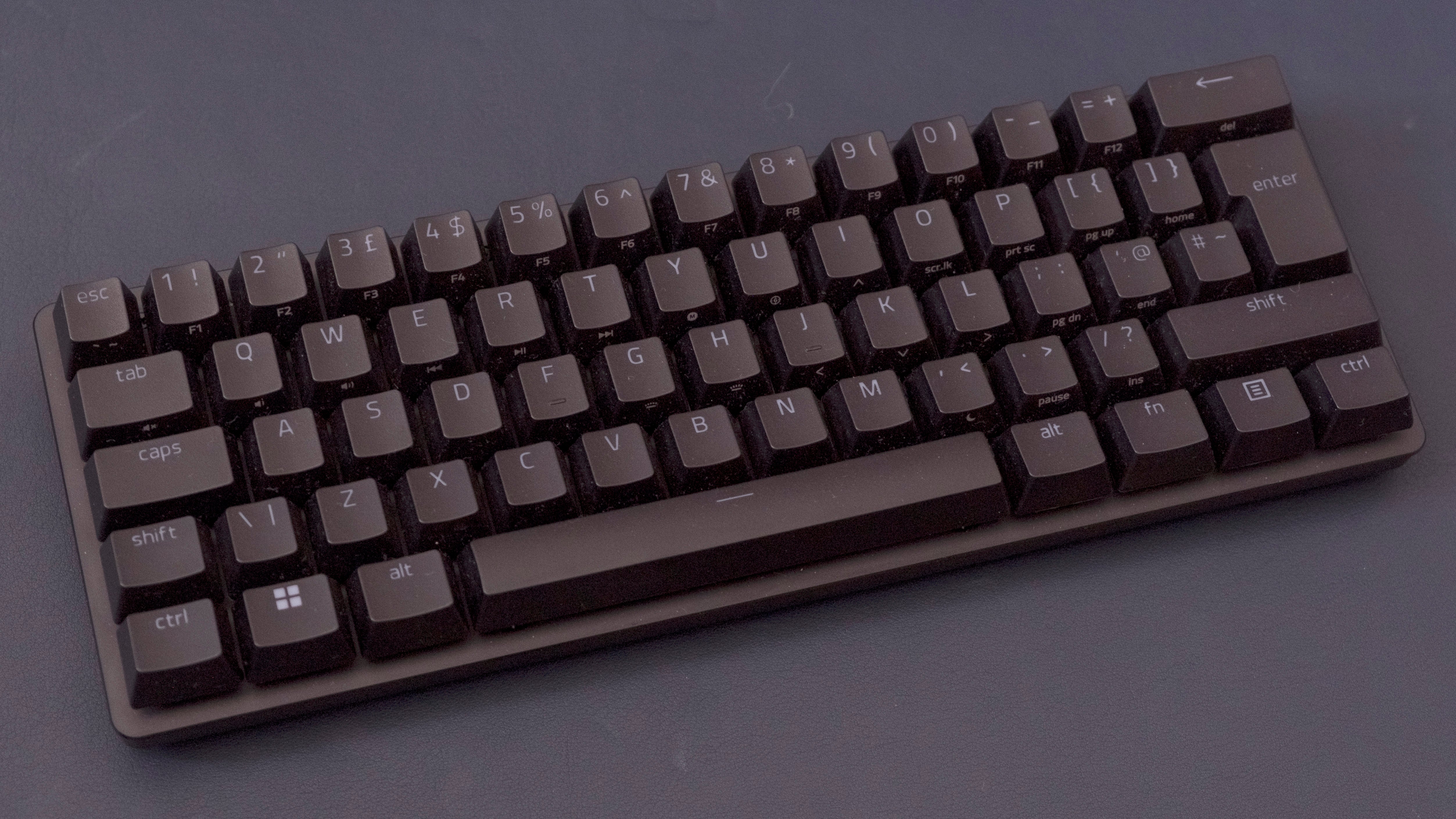a razer huntsman mini analog keyboard, with a compact and simple black plastic chassis but more interesting analogue switches beneath