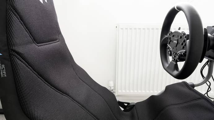 moza r5 bundle mounted on a playseat challenge x logitech g edition folding racing cockpit, zoomed in