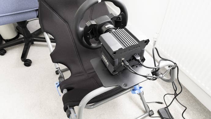 moza r5 wheelbase with connections mounted on a playseat challenge x cockpit