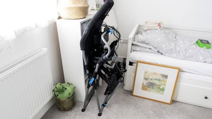 moza r5 bundle mounted on a playseat challenge x logitech g edition folding racing cockpit, folded up in a corner