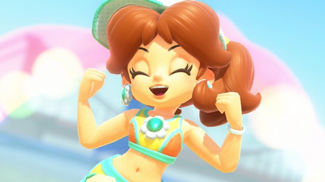Daisy in Mario Kart World jumping with her arms held in celebration