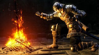 A hero in armour sits before a bonfire in Dark Souls