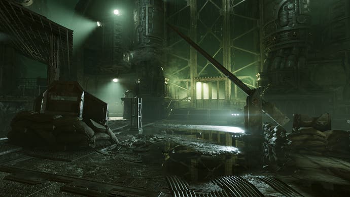 Darktide preview - a dark industrial area lit in eerie green
