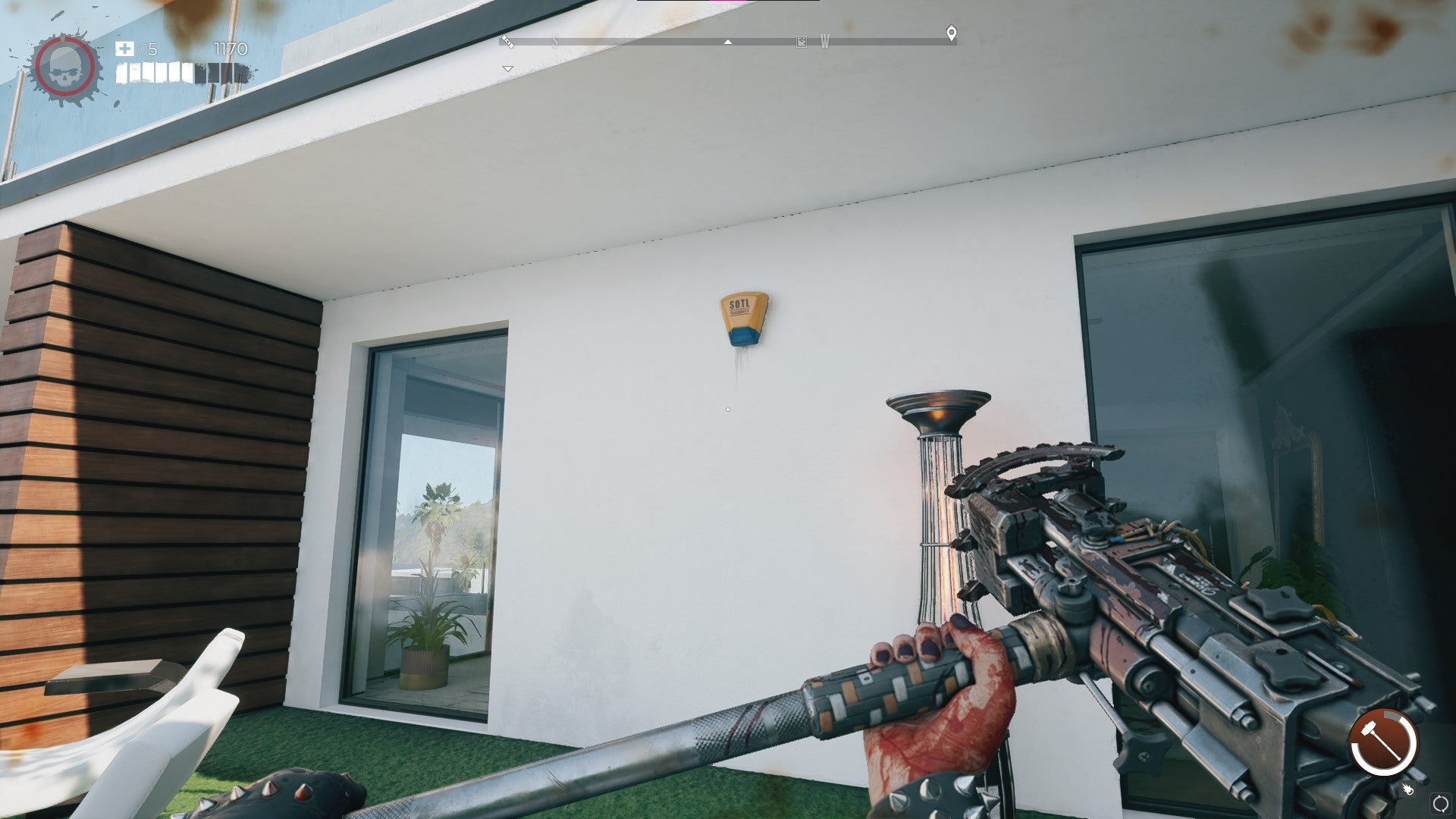 The player looks at an alarm on the exterior of the Goat Pen in Dead Island 2